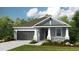Charming single-story home showcasing a well-manicured lawn and attached two-car garage at 720 Sky Shade Dr, Apollo Beach, FL 33572