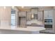 Beautiful kitchen with gray cabinets, stainless steel appliances, and a spacious island at 720 Sky Shade Dr, Apollo Beach, FL 33572