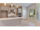 Bright kitchen featuring gray cabinets, stainless appliances, island, and wood-look flooring at 720 Sky Shade Dr, Apollo Beach, FL 33572