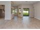Bright, open-concept living room with wood-look flooring and a view of the kitchen at 720 Sky Shade Dr, Apollo Beach, FL 33572