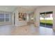 Open-concept living room and kitchen area with sliding glass doors to the backyard at 720 Sky Shade Dr, Apollo Beach, FL 33572