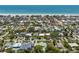 An aerial view of a coastal neighborhood with homes and streets leading to a pristine beach and blue ocean at 759 Lantana Ave, Clearwater Beach, FL 33767