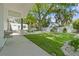 Lush backyard featuring a verdant lawn, manicured landscaping, and a charming fire pit area at 759 Lantana Ave, Clearwater Beach, FL 33767