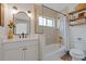 Bathroom with modern vanity, bathtub with shower, and decorative shelving at 759 Lantana Ave, Clearwater Beach, FL 33767
