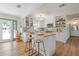 Well-lit kitchen featuring white cabinets, an island with seating, and an open layout perfect for entertaining at 759 Lantana Ave, Clearwater Beach, FL 33767