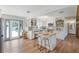 Bright, modern kitchen with white cabinets, wood countertops, an island with seating, and access to the pool area at 759 Lantana Ave, Clearwater Beach, FL 33767