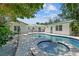 A charming outdoor living space with a pool and connecting jacuzzi between two white buildings at 759 Lantana Ave, Clearwater Beach, FL 33767