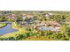 Aerial view featuring community pool and clubhouse, surrounded by verdant landscaping at 8605 Grand Alberato Rd, Tampa, FL 33647