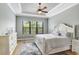 Comfortable bedroom with tray ceiling, large window, and stylish furnishings, creating a relaxing retreat at 8605 Grand Alberato Rd, Tampa, FL 33647