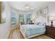 Cozy bedroom with natural light, hardwood floors, and a serene color palette at 8605 Grand Alberato Rd, Tampa, FL 33647