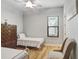 Comfortable bedroom with neutral walls, wood-look floors, and a ceiling fan at 8605 Grand Alberato Rd, Tampa, FL 33647