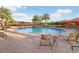 Community pool with sun loungers, cabanas and lush landscaping at 8605 Grand Alberato Rd, Tampa, FL 33647
