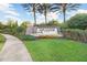 Landscaped community sign for Esplanade of Tampa, including decorative plantings and walkway at 8605 Grand Alberato Rd, Tampa, FL 33647