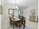 Formal dining room featuring a chandelier, hardwood table, and ornate decor at 8605 Grand Alberato Rd, Tampa, FL 33647