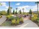 Community fire pit and seating area surrounded by lush landscaping and walking path at 8605 Grand Alberato Rd, Tampa, FL 33647