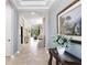 Elegant foyer showcasing tile flooring, high ceilings, and an open view to the living room at 8605 Grand Alberato Rd, Tampa, FL 33647