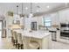 Modern kitchen featuring granite counters, stainless steel appliances, a large island, and bar stool seating at 8605 Grand Alberato Rd, Tampa, FL 33647