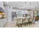 Gourmet kitchen with white cabinetry, stainless steel appliances, and large island with seating at 8605 Grand Alberato Rd, Tampa, FL 33647