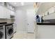 Bright laundry room featuring washer and dryer, storage cabinets, and convenient countertop space at 8605 Grand Alberato Rd, Tampa, FL 33647