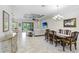Open living room with elegant dining area, tile floors, and access to the outdoor patio at 8605 Grand Alberato Rd, Tampa, FL 33647