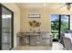 Outdoor kitchen featuring stainless steel appliances, sink, and countertop space for easy entertaining at 8605 Grand Alberato Rd, Tampa, FL 33647