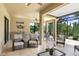 Outdoor patio with a full kitchen, ceiling fans, comfortable seating, and a screened-in section at 8605 Grand Alberato Rd, Tampa, FL 33647