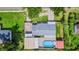 Bird's-eye view of the property featuring a well-maintained yard, sheds, pool, and hardscape at 915 S Miller Rd, Valrico, FL 33594