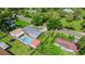 An aerial view shows the property's sheds, pool, fenced back yard, and proximity to a road at 915 S Miller Rd, Valrico, FL 33594