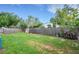 Large grassy backyard surrounded by a wooden fence and mature trees at 915 S Miller Rd, Valrico, FL 33594