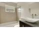 Bright bathroom with vanity sink, modern fixtures, and bathtub with shower at 915 S Miller Rd, Valrico, FL 33594