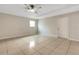 Bright bedroom featuring a ceiling fan, tile floors, and a cozy atmosphere, perfect for relaxation at 915 S Miller Rd, Valrico, FL 33594