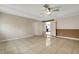 Neutral bedroom featuring a ceiling fan, tile floors, and access to another room at 915 S Miller Rd, Valrico, FL 33594