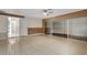 Bright bedroom featuring a ceiling fan, tile floors, and sliding glass doors leading to a walk-in closet at 915 S Miller Rd, Valrico, FL 33594