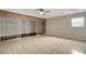 Bright bedroom featuring a ceiling fan, tile floors, and sliding glass doors leading to a walk-in closet at 915 S Miller Rd, Valrico, FL 33594