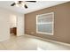 Bedroom with a ceiling fan, window, closet and an attached bathroom, offering convenience and comfort at 915 S Miller Rd, Valrico, FL 33594
