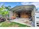 Spacious carport with metal roof and plywood walls, offering ample covered storage or parking space at 915 S Miller Rd, Valrico, FL 33594