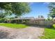 Exterior view of the home showing its front lawn, driveway, and attached garage, complemented by mature trees at 915 S Miller Rd, Valrico, FL 33594