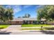 Charming single-story home with a well-manicured lawn and a classic red front door at 915 S Miller Rd, Valrico, FL 33594
