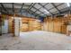 Spacious garage featuring storage shelves and metal ceiling, perfect for projects and organization at 915 S Miller Rd, Valrico, FL 33594