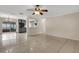 An open living room with tile floors leads to a kitchen with gray cabinets and stainless appliances at 915 S Miller Rd, Valrico, FL 33594
