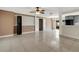 Living room with tile floors leading to a kitchen area and hall, all bathed in natural light at 915 S Miller Rd, Valrico, FL 33594