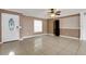 Living room with tile floors, ceiling fan, and a window near the front door for natural lighting at 915 S Miller Rd, Valrico, FL 33594