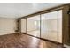 Room featuring wood floors next to another room with tile floors separated by a glass sliding door at 915 S Miller Rd, Valrico, FL 33594