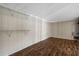A room features wooden paneling, a ceiling and floors, and metal shelving providing ample storage space at 915 S Miller Rd, Valrico, FL 33594