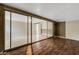 Room featuring wood floors next to another room with tile floors separated by a glass sliding door at 915 S Miller Rd, Valrico, FL 33594
