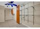 Room with tile floors, blue ceiling fan, and metal shelving and cabinets, offering ample storage at 915 S Miller Rd, Valrico, FL 33594