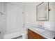 Bathroom featuring a classic white subway tile shower and a wood vanity with a marble countertop at 101 E Lambright St, Tampa, FL 33604