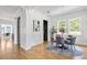 Dining room with hardwood floors, a round table with seating for four, and natural light from multiple windows at 101 E Lambright St, Tampa, FL 33604