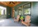 Spacious front porch with wood ceiling and chairs provides relaxing outdoor space at 101 E Lambright St, Tampa, FL 33604