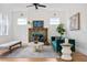 Bright living room with tiled fireplace, modern furnishings, hardwood floors, and two windows for natural light at 101 E Lambright St, Tampa, FL 33604